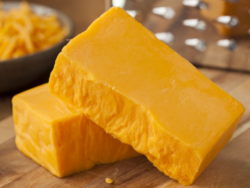 Sharp Cheddar Cheese on a Wooden Cutting Board
