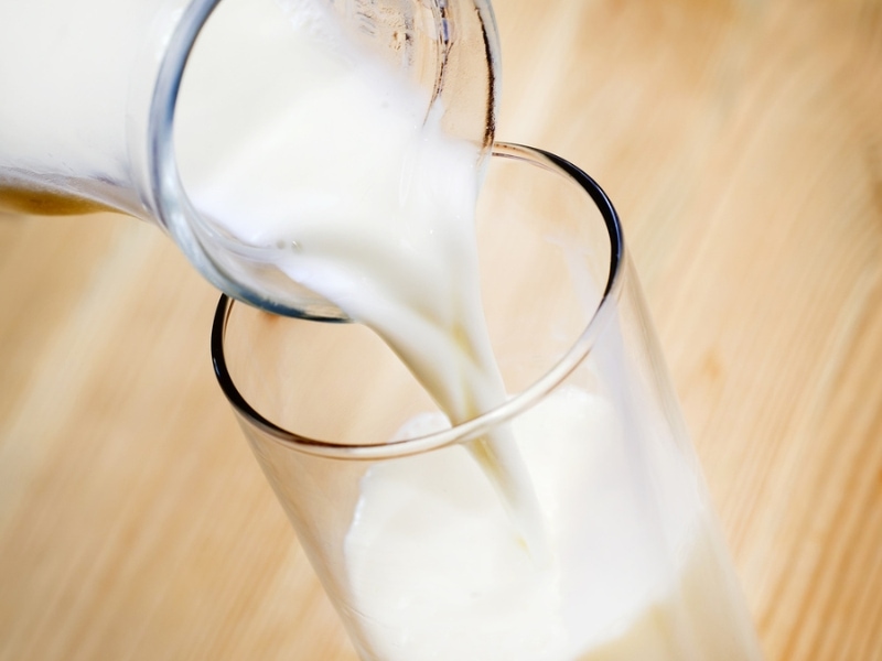 Jar of Skimmed Milk Poured into a Drinking Glass