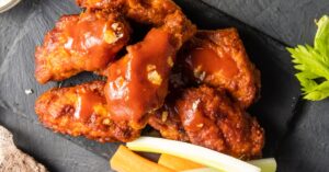 Spicy Buffalo Wings with Sauce and Vegetables