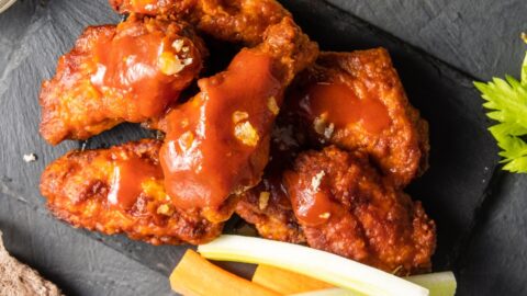 Spicy Buffalo Wings with Sauce and Vegetables