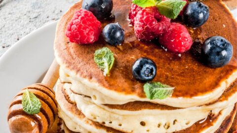 Stack of Oat Flour Pancakes with Fresh Berries on Top