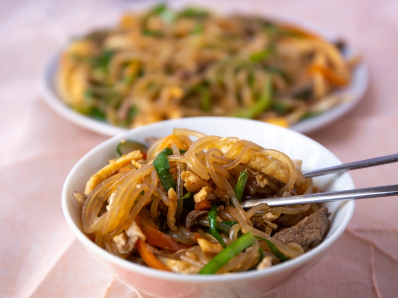 Stir Fried Glass Noodles with Vegetables and Meat  in a Small Bowl