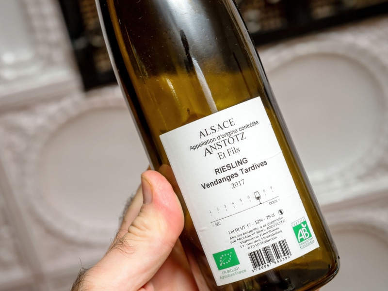 A Man's Hand Holding a Bottle of Sweet Riesling 