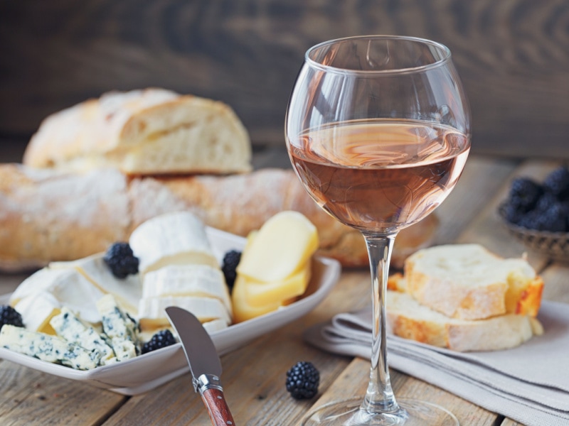 A Glass of Vin Doux Naturel Serve with Bread, Cheese, and Berries
