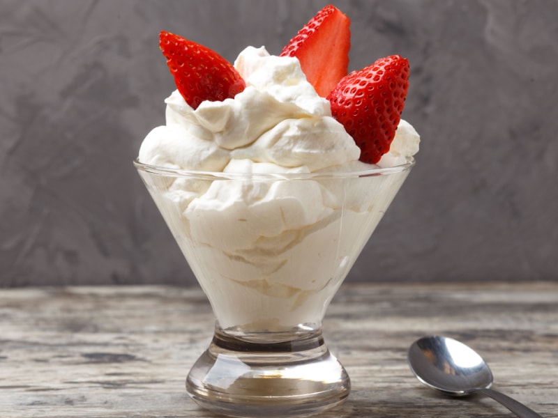 A Glass of Whipped Cream with Strawberries on Top