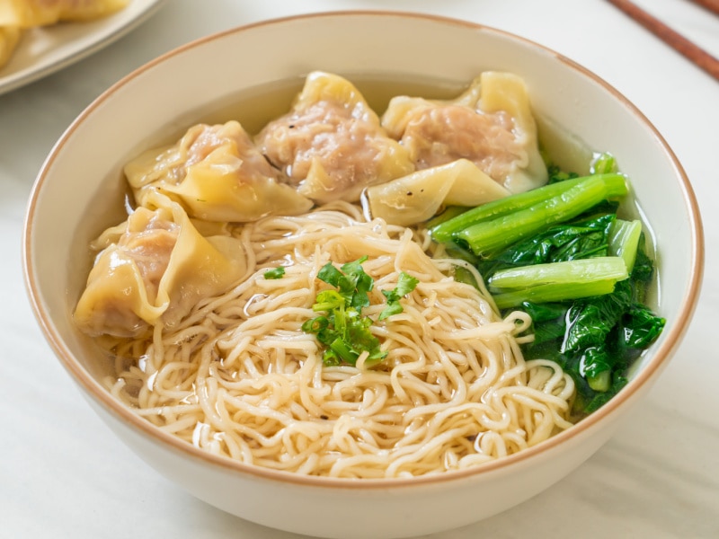 Bowl of Wonton Noodle Soup with Pork Dumplings and Bok Choy