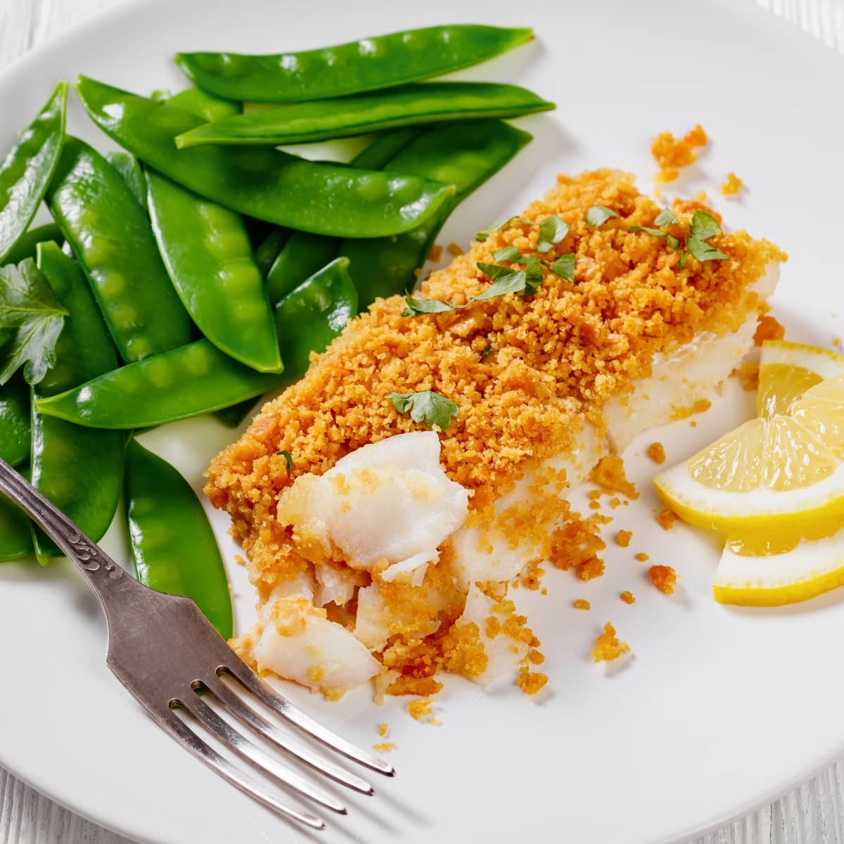 Baked Cod with Green Peas Pods and Lemon