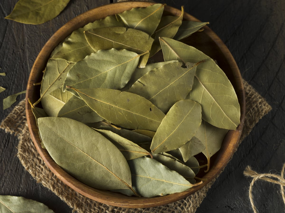 Raw Organic Dry Bay Leaves in a Wooden Bowl