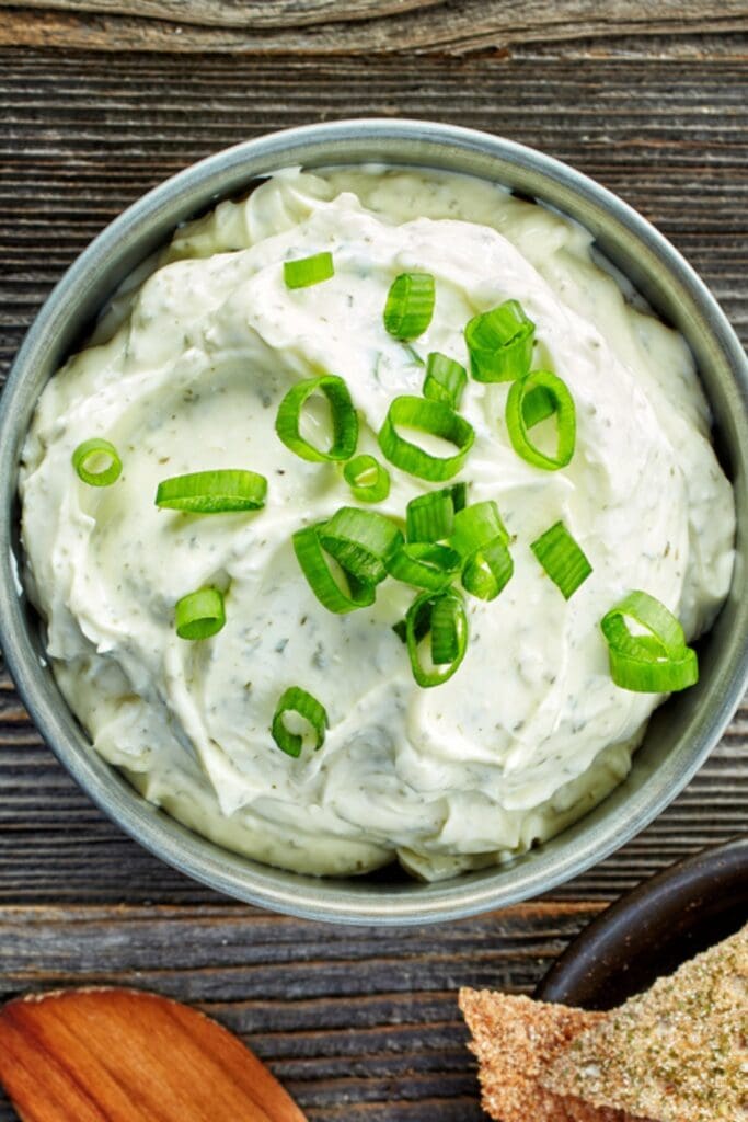 The Best Blue Cheese Dip Recipe (Easy) featuring Bowl of Homemade Blue Cheese Dip Topped with Green Onion Slices