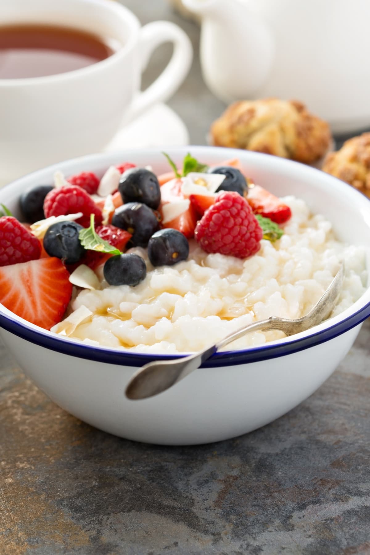 Bowl of Rice Pudding with Berries Served with Coffee