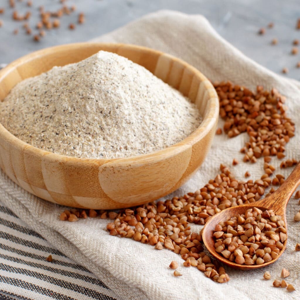 Buckwheat Powder on a Bowl and Buckwheat on a Wooden Spoon
