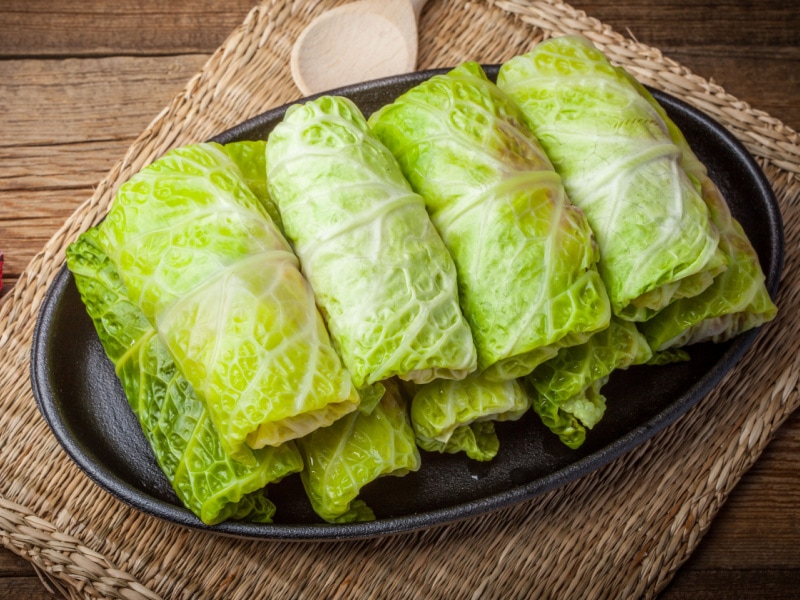 Cabbage Rolls Stuffed with Meats and Grits on a Cast Iron Plate