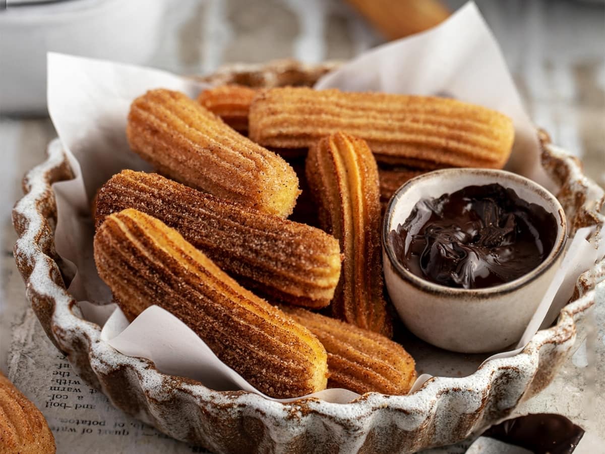 Churros On A Plate With Chocolate Dip