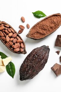 Composition of Cocoa Powder and Beans on a White Background