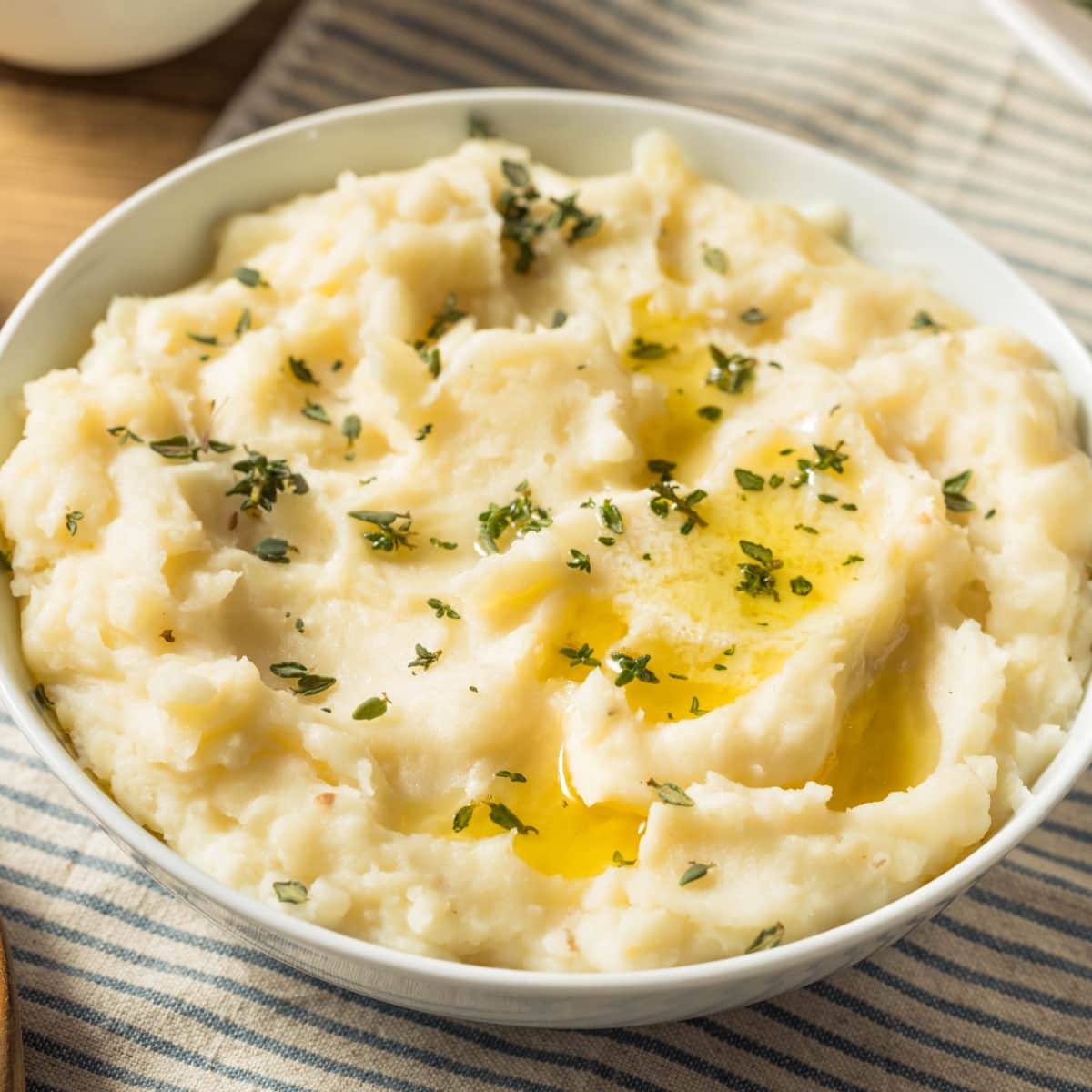 Bowl of Mashed Potatoes with Melted Butter and Herbs