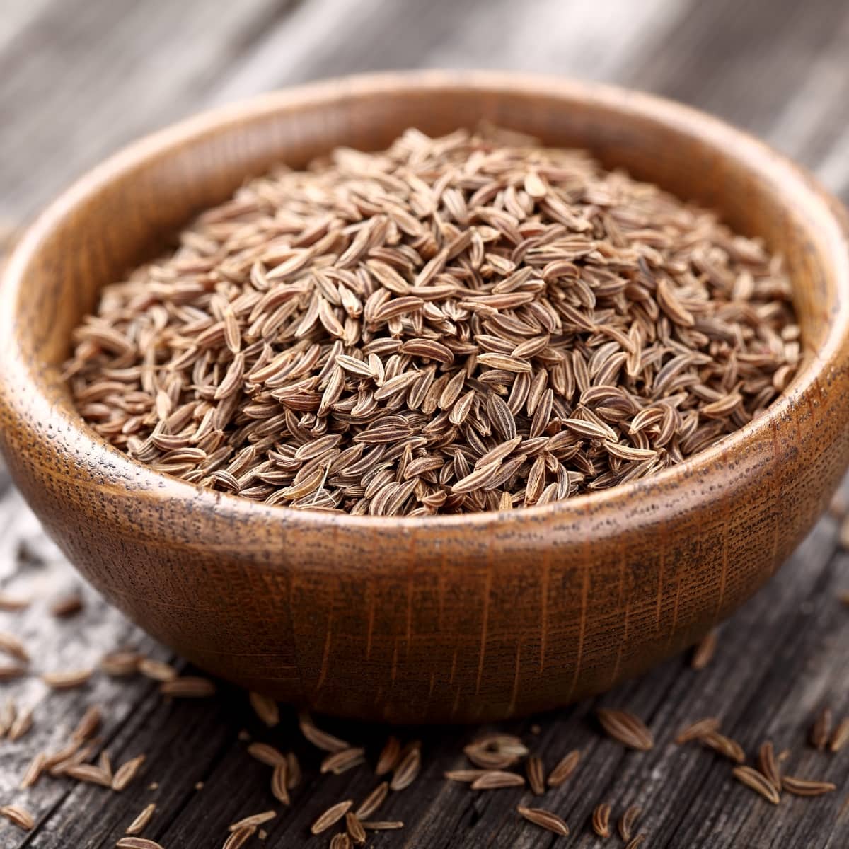 Cumin Seeds in a Wooden Bowl