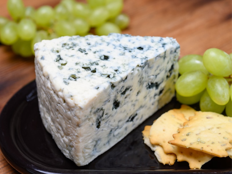 Danish Daniblue Cheese with Green Grapes and Crackers on a Plate