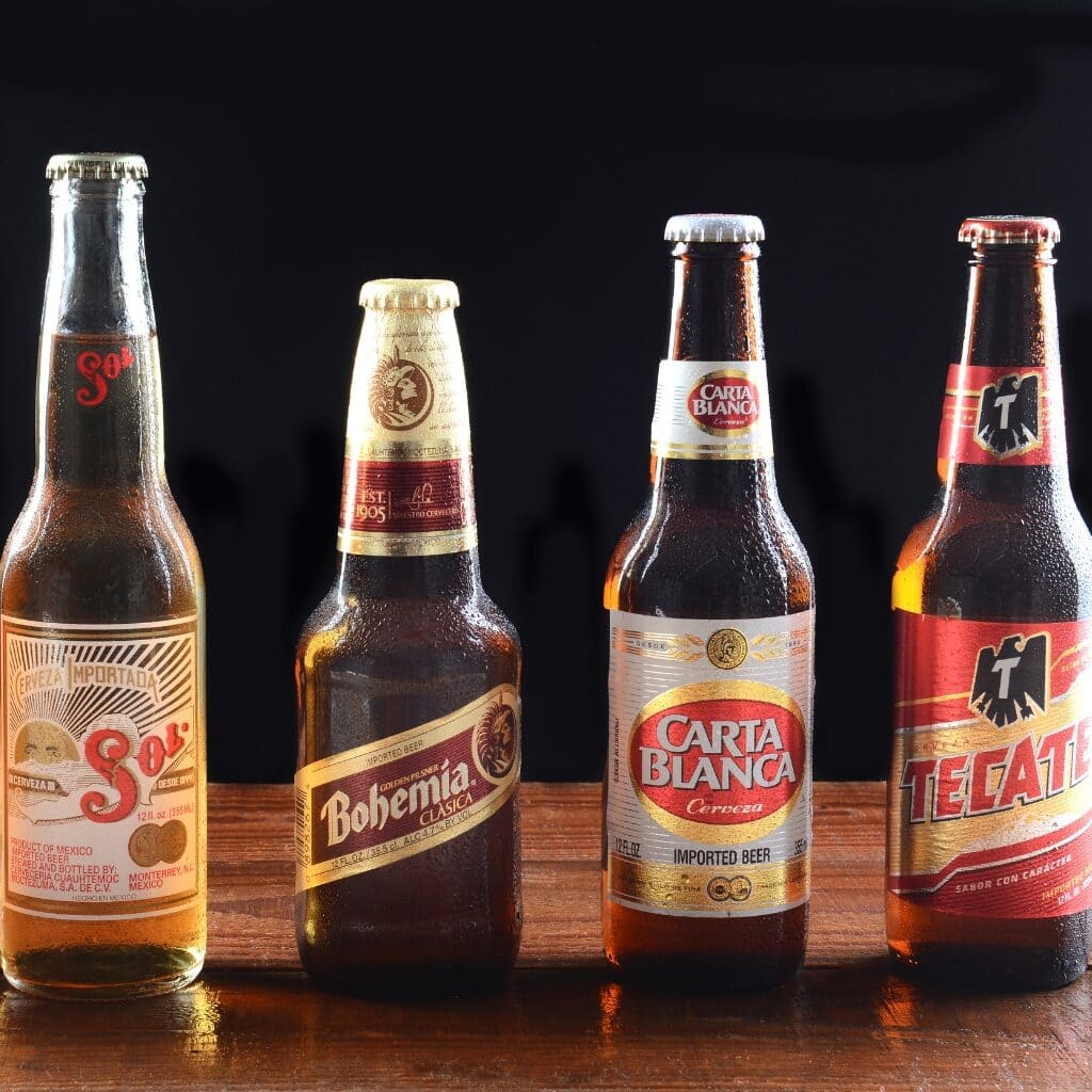 13 Best Mexican Beers To Try (Most Popular) featuring Different Cold Mexican Beers Including Sol, Bohemia, Carta Blanca and Tecate