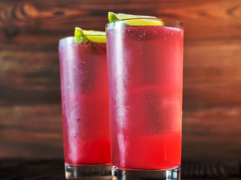 Two El Diablo Cocktails Garnished with Lime Wedges