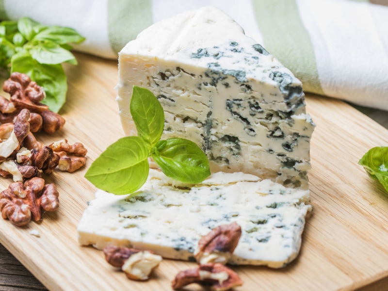 Fourme d’Ambert Blue Cheese and Walnut on a Wooden Cutting Board