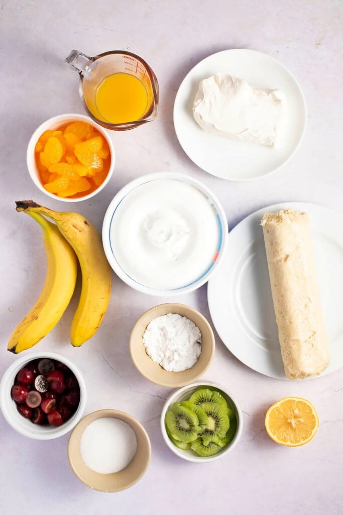 Fruit Pizza Ingredients - Sugar Cookie Dough, Cream Cheese, Confectioner's Sugar, Frozen Whipped Topping, Fruits, Sugar, Water, Orange and Lemon Juice