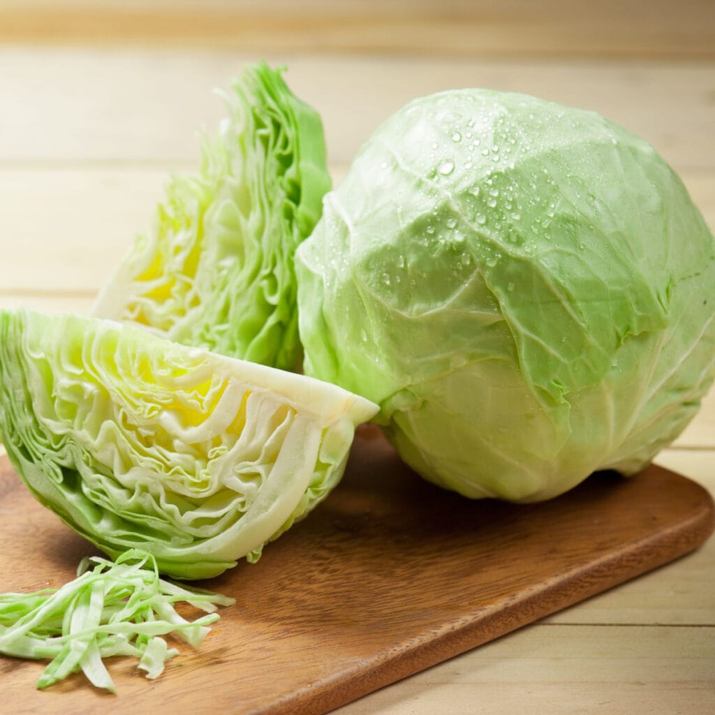 Fresh Green Cabbage on a Wooden Cutting Board