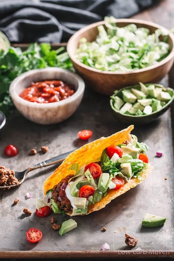 Taco with ground beef, avocado, tomato and lettuce filling. 
