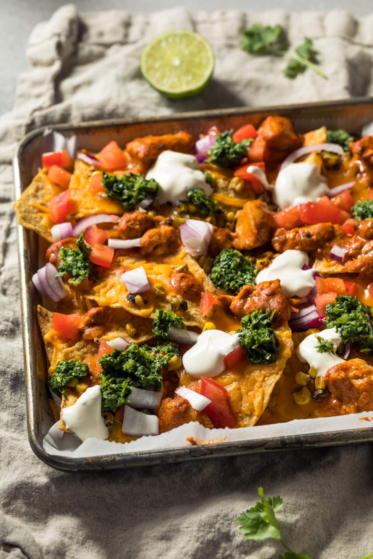 50 Easy Recipes That Will Feed a Crowd featuring Homemade Chicken Nachos with Broccoli, Onions and Tomatoes