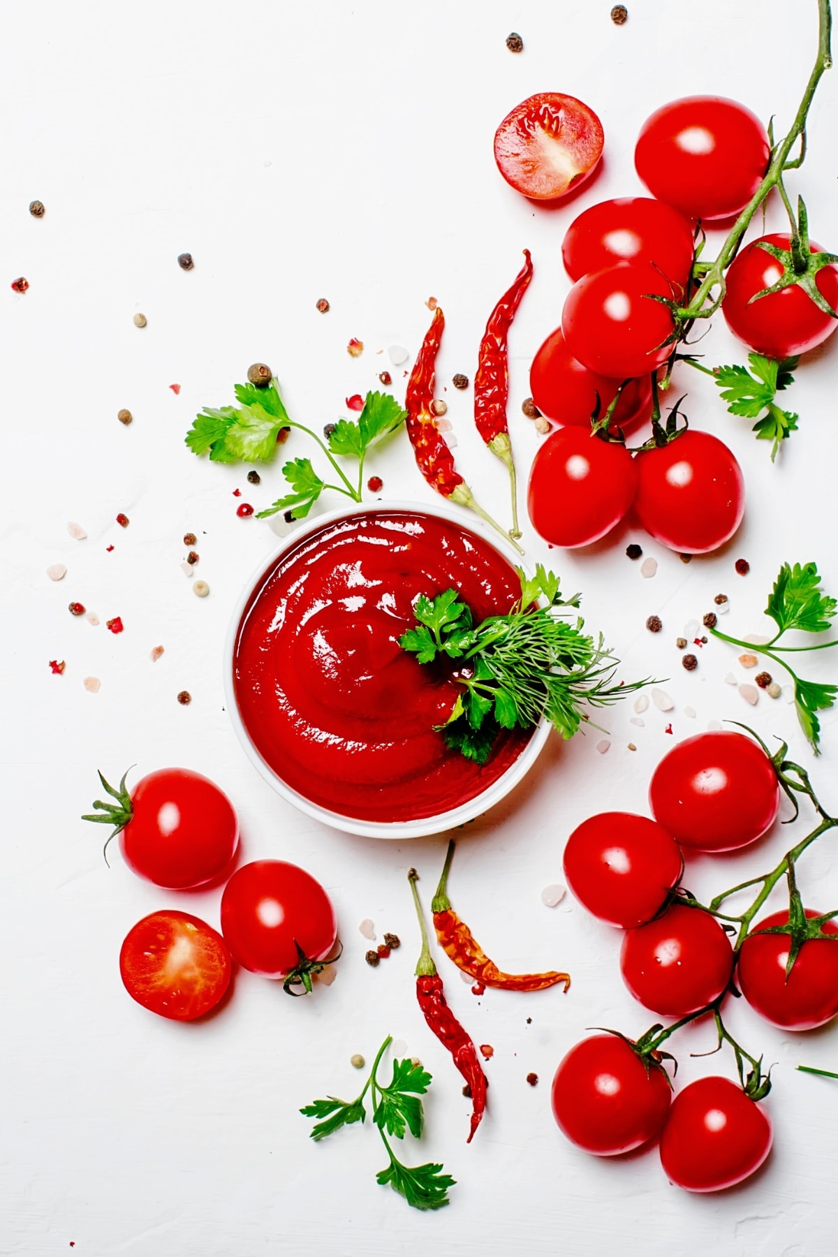 Homemade Ketchup with Chili Peppers on a White Background