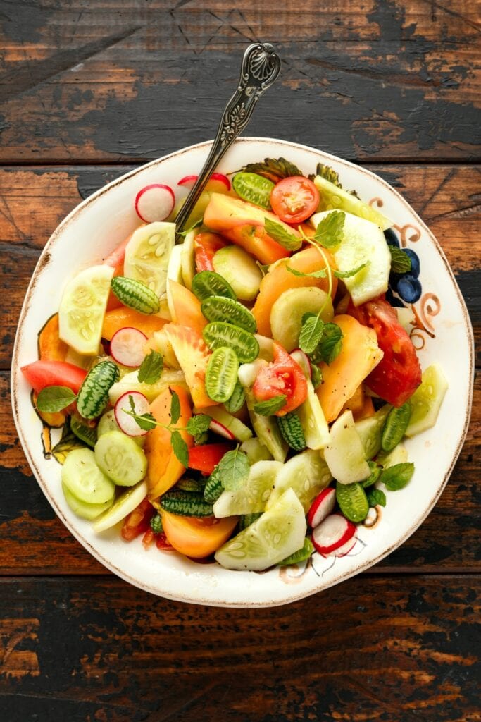 Homemade Vegan Salad with Lemon, Cucumber, Radishes and Tomatoes