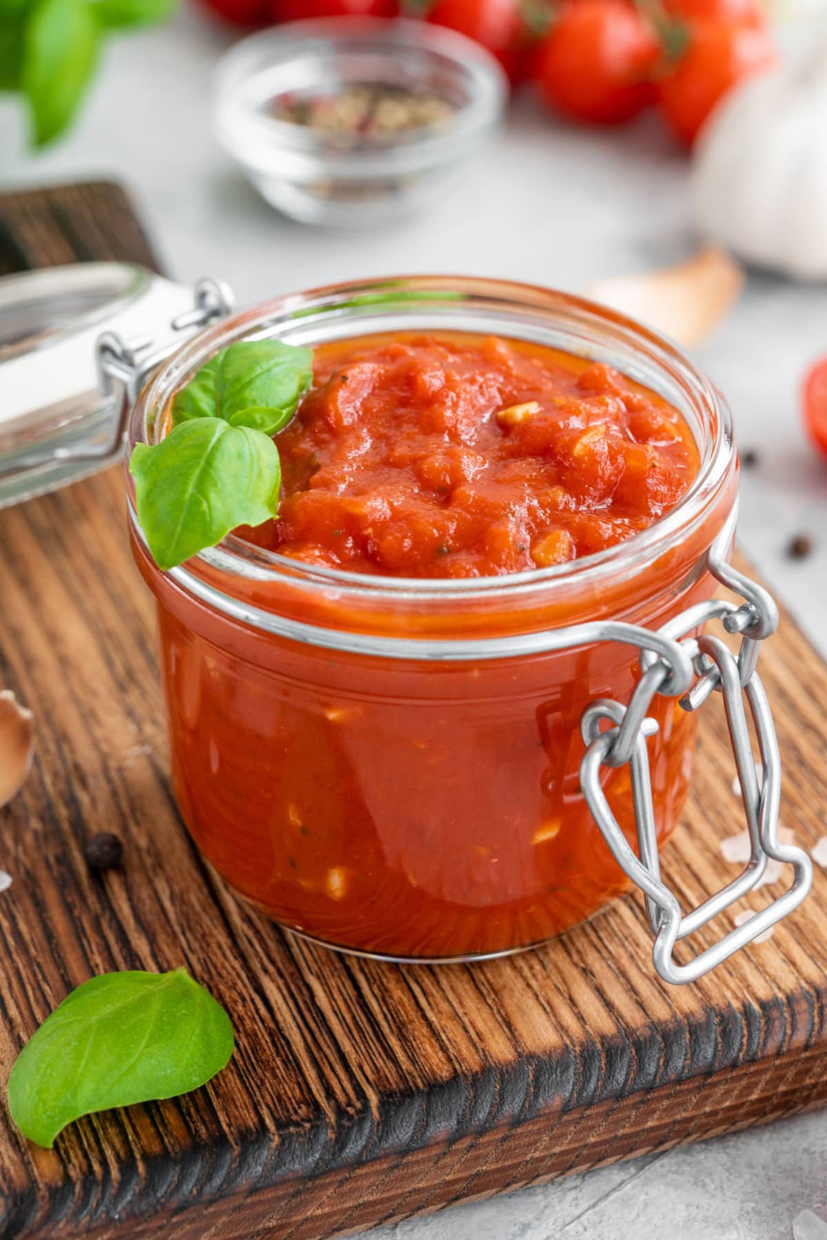 Traditional Marinara Sauce on a Jar with Spices on the Background