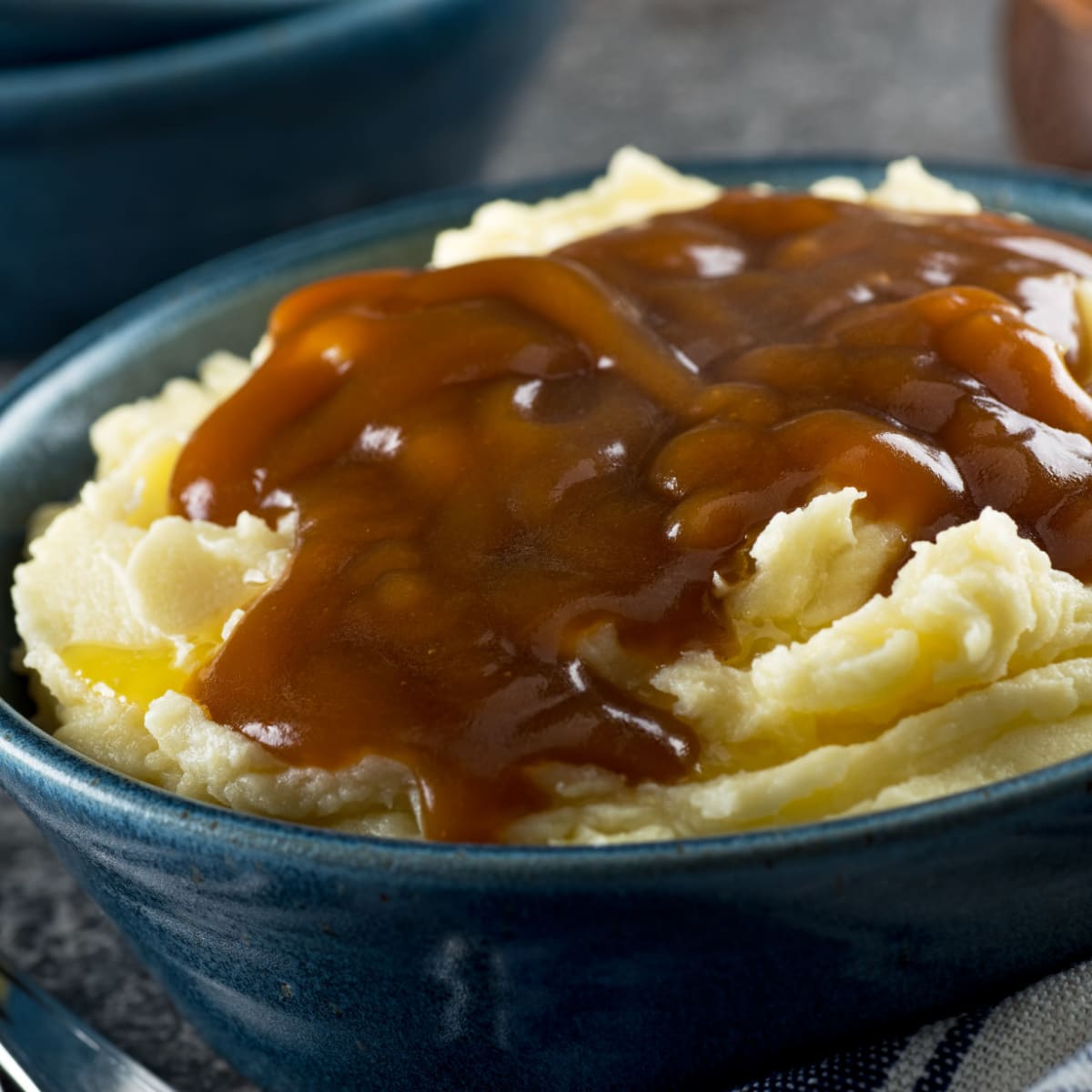 Bowl of Mashed Potatoes with Butter and Brown Gravy