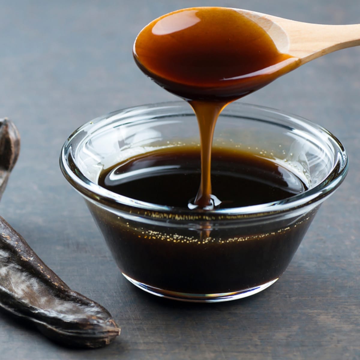 Wooden Spoon Scooping Molasses Syrup