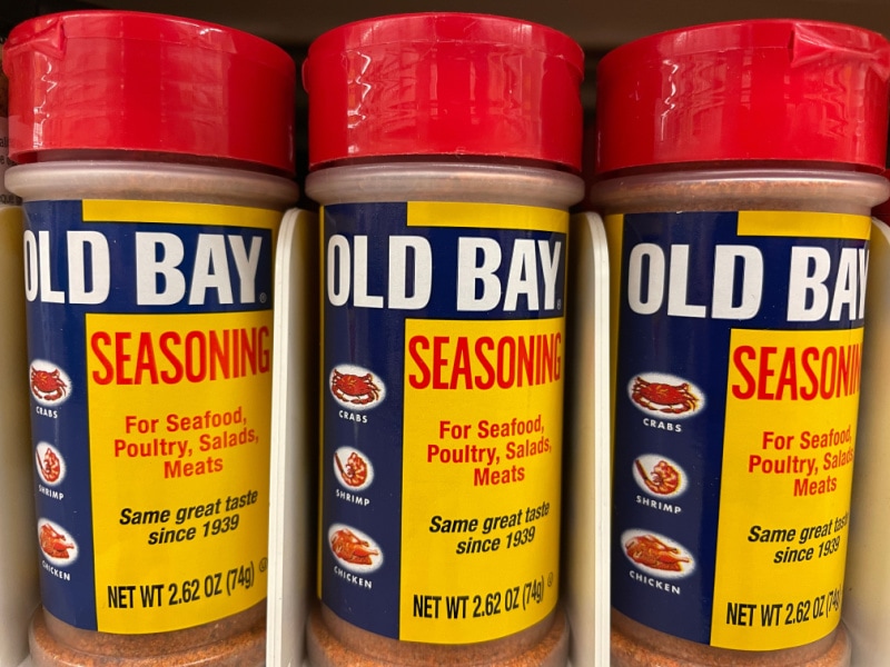 3 Containers of Old Bay Seasoning on Shelves
