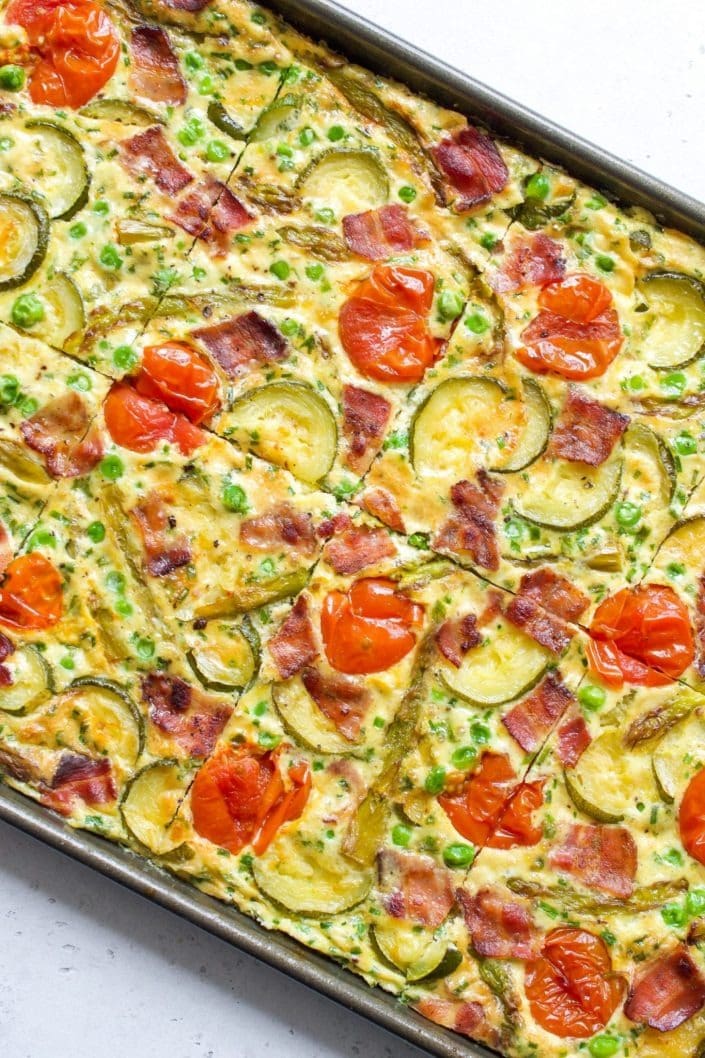 One-pan eggs with asparagus and tomatoes in a sheet pan. 
