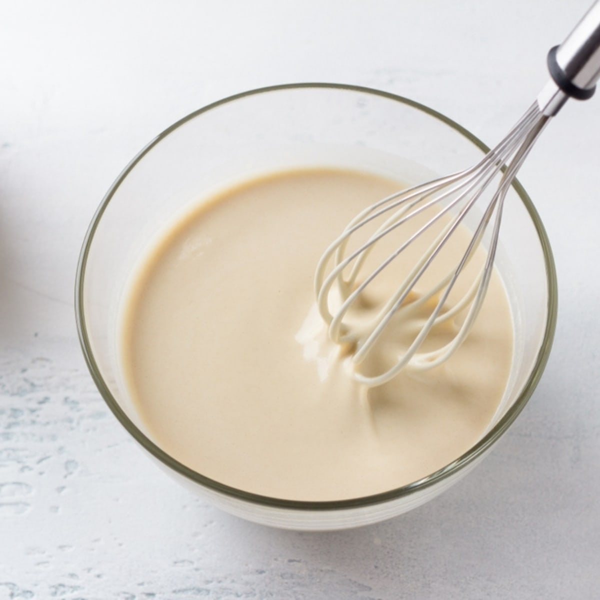 Pancake Batter With Whisk in a Glass Bowl