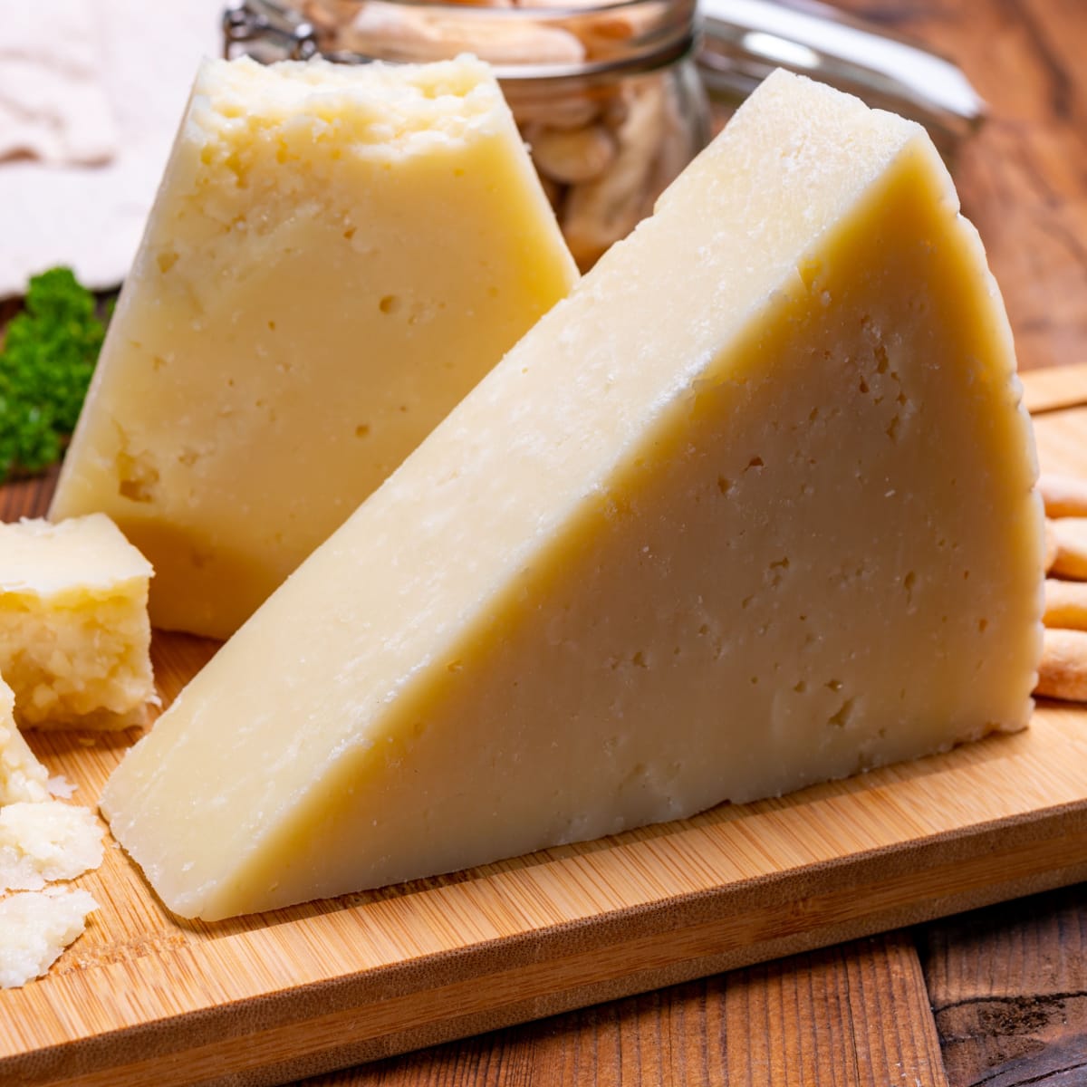 Slices of Matured Pecorino Romano Cheese on a Wooden Cutting Board