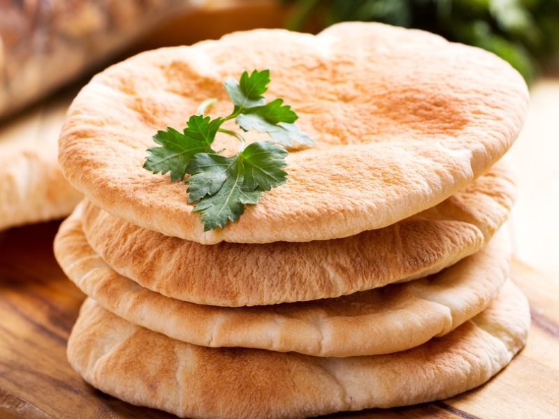 Stack of Pita Bread on Wooden Board