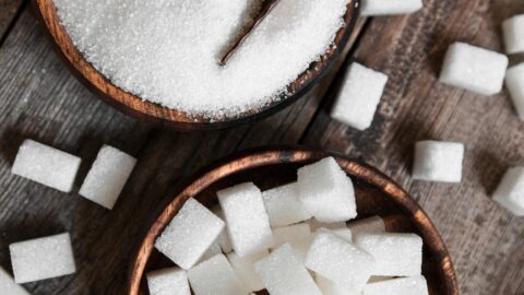 Raw Organic Refined and Cubed Hard Sugar in a Wooden Bowl