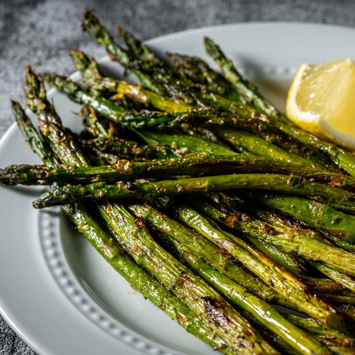 Roasted Asparagus With Sliced Lemon in Plate