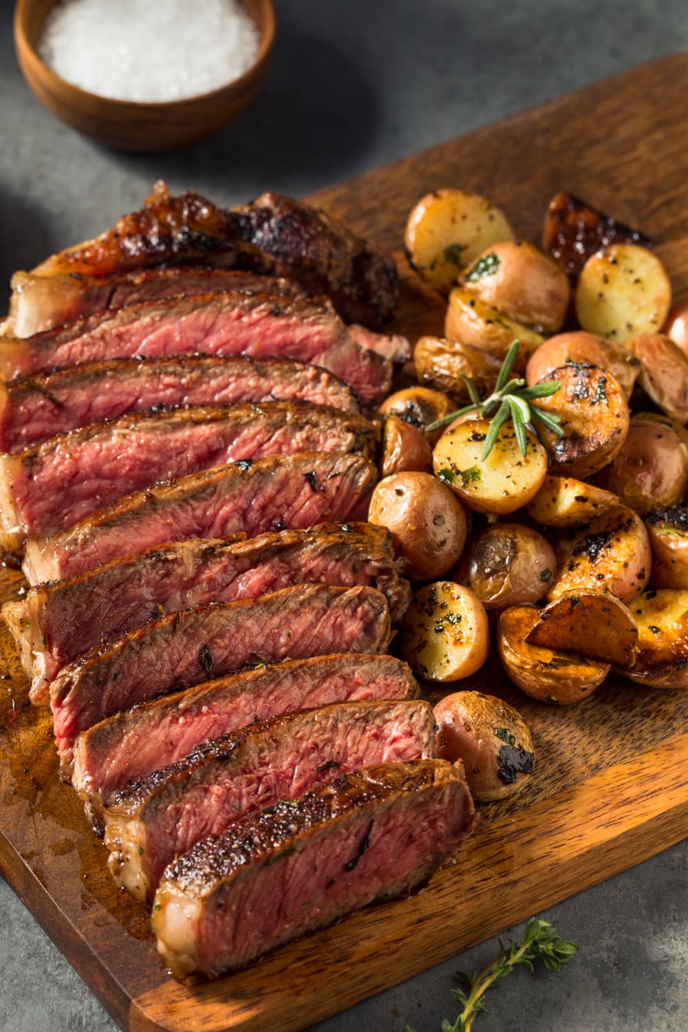 Sliced Steak With Roasted Baby Potatoes on Sides