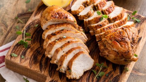 Sliced Crockpot Chicken Breast on a Wooden Board