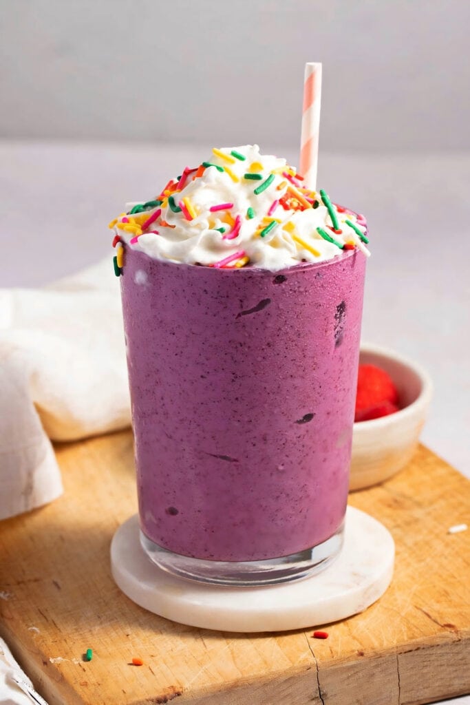 The Best Grimace Shake Recipe (McDonald's Copycat) featuring Sweet and Fruity Grimace Shake with Whipped Cream and Sprinkles