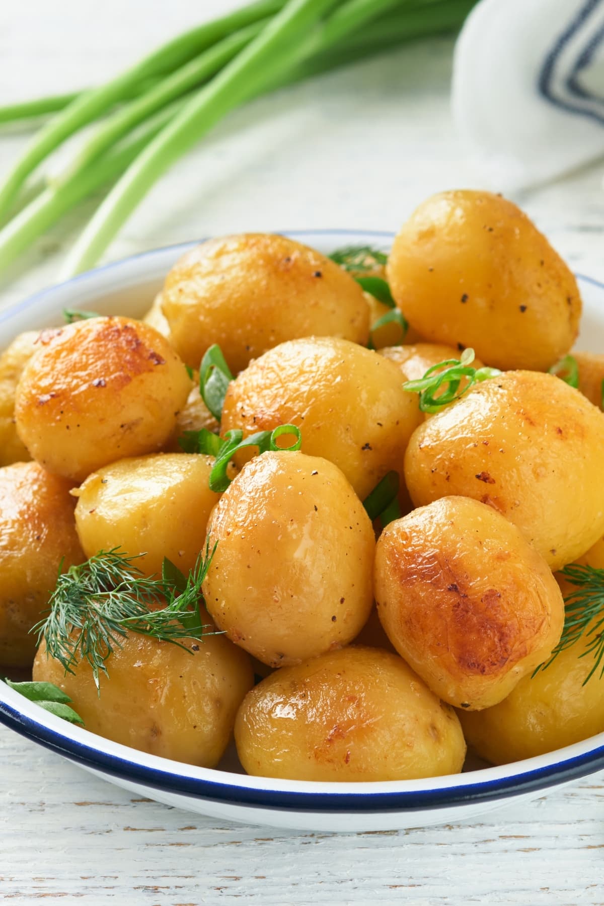 Young potatoes with butter, dill and onions