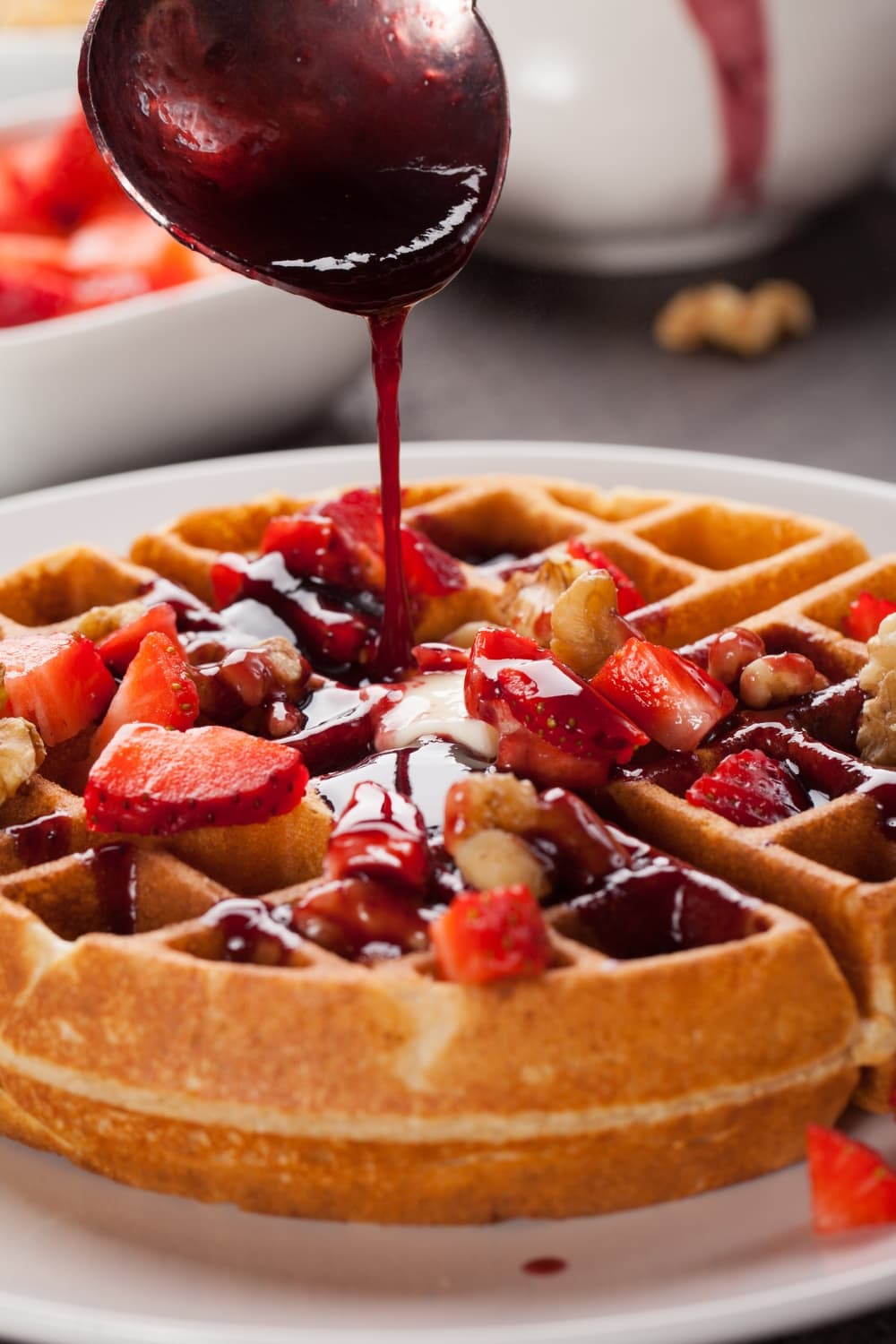 Belgian Waffle Topped With Sliced Berries, Drizzled With Syrup