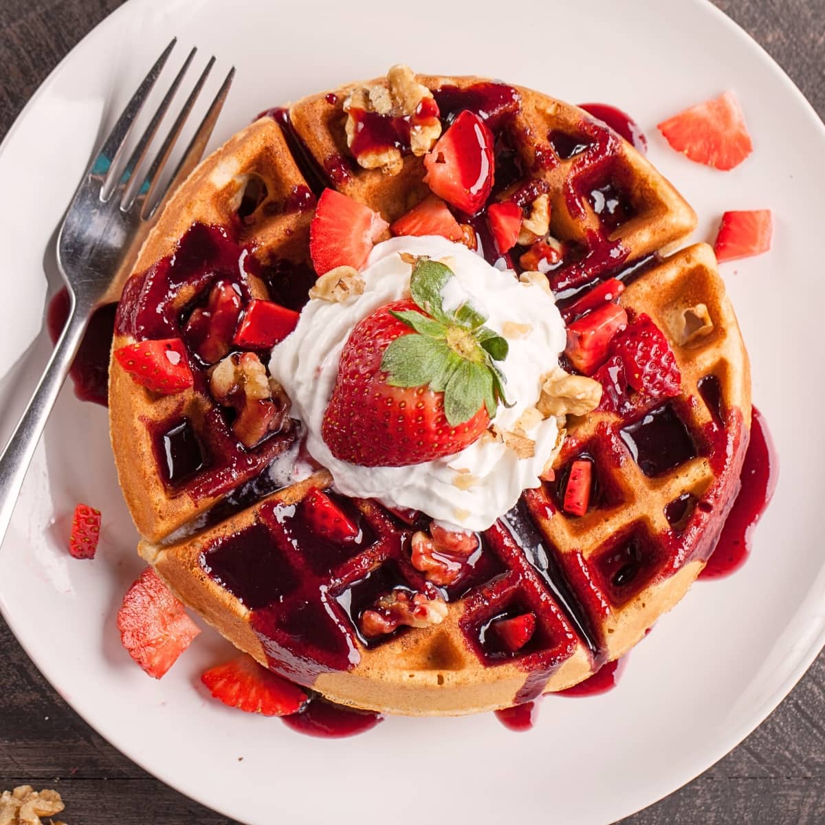 Belgian Waffles Served With Fresh Strawberries, Whipped Cream, Syrup and Nuts