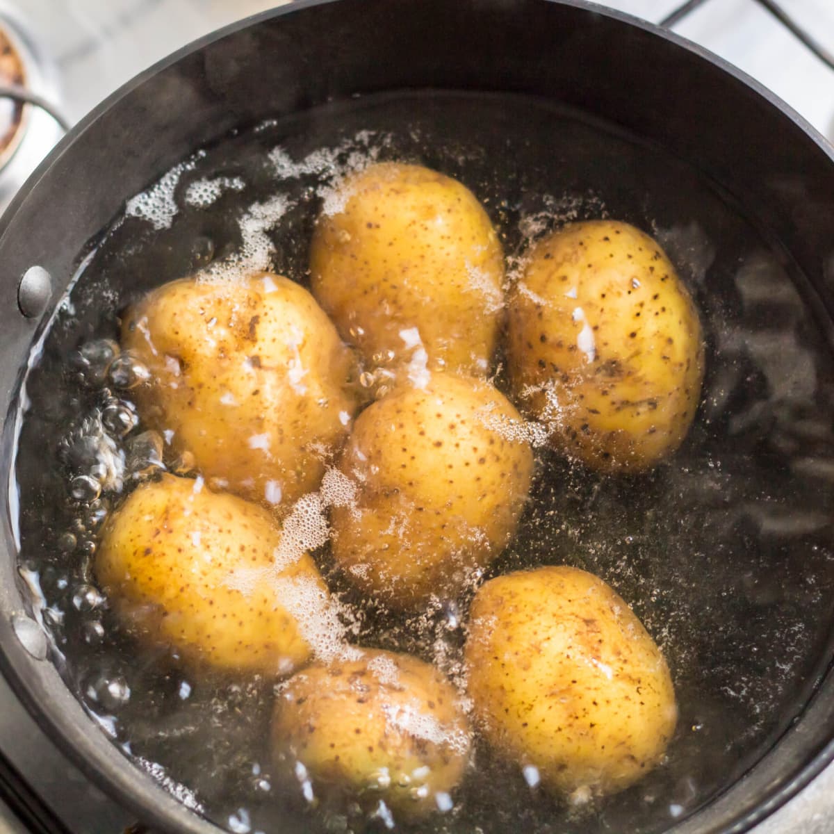 Raw Potatoes Boiling on a Pot of Hot Water