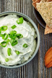 Bowl of blue cheese dip with chopped green onions