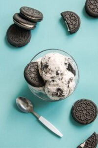 Bowl of Cookies and Cream Ice Cream on a Blue Background
