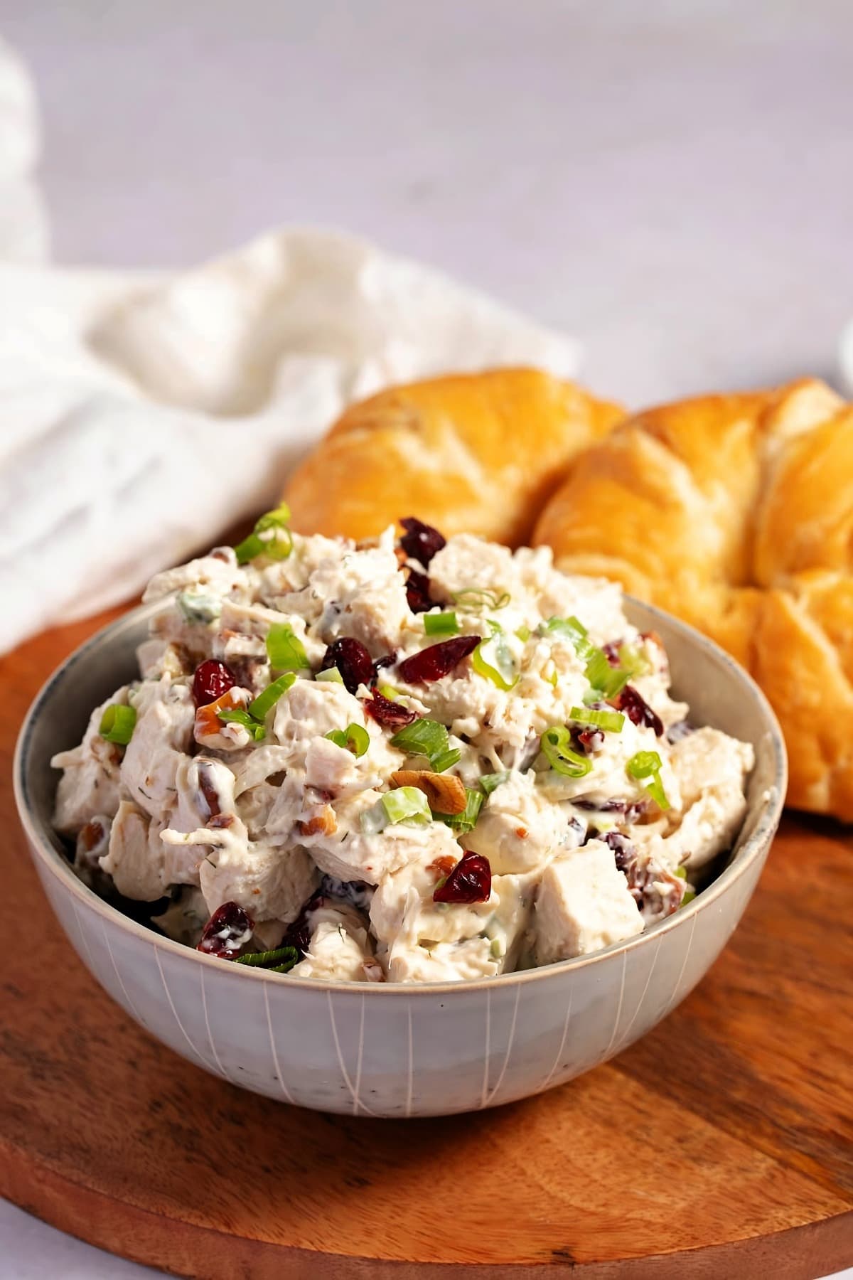 Fresh Breads with a bowl of salad with chicken, mayonnaise, green onions, dried cranberries, chopped pecans, lime juice, and dried dill weed.